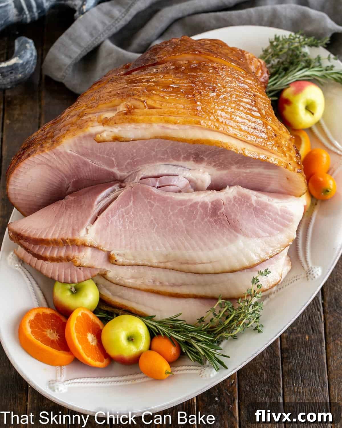 Overhead view of a honey mustard glazed ham on a serving platter.