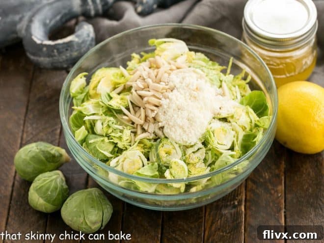Ingredients for shaved brussels sprouts salad laid out on a wooden surface.
