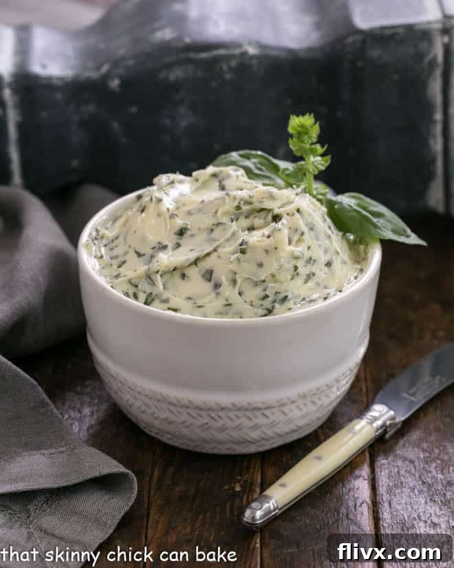 Basil butter in a white bowl with a small knife