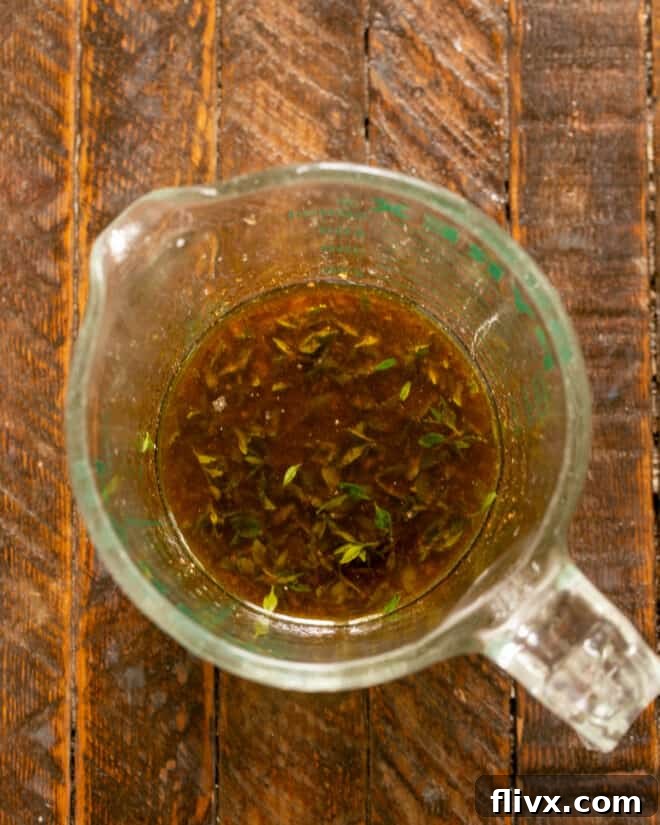 Whisking together marinade ingredients in a bowl.