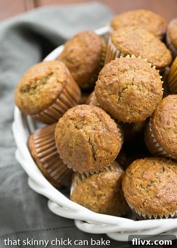 A charming white ceramic basket overflowing with perfectly baked Buttermilk Bran Muffins, showcasing their golden-brown tops and moist interior. A delicious and wholesome breakfast treat.