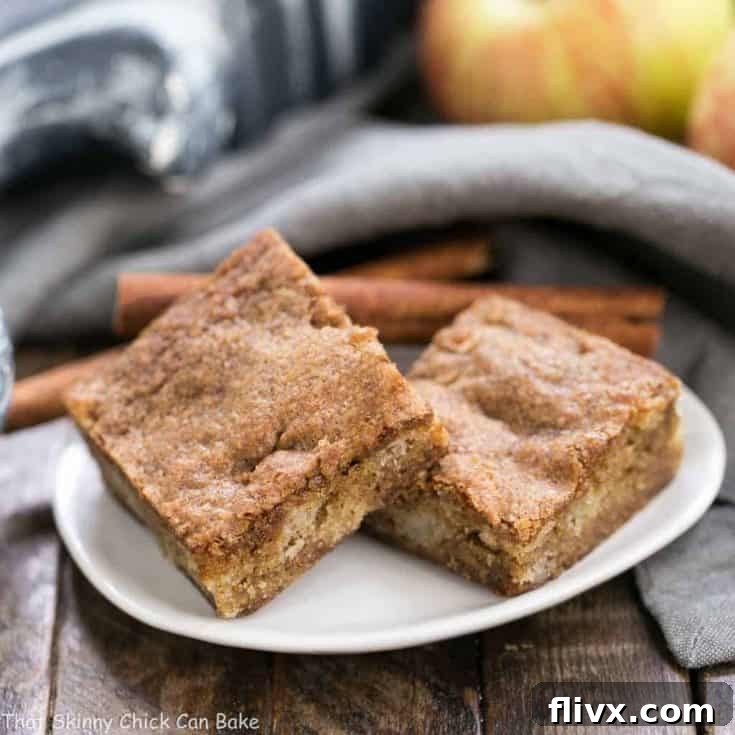 Cinnamon Apple Blondies (Apple Brownies) - A close-up of beautifully baked bar cookies with visible apple chunks and a warm golden hue, ready for serving.