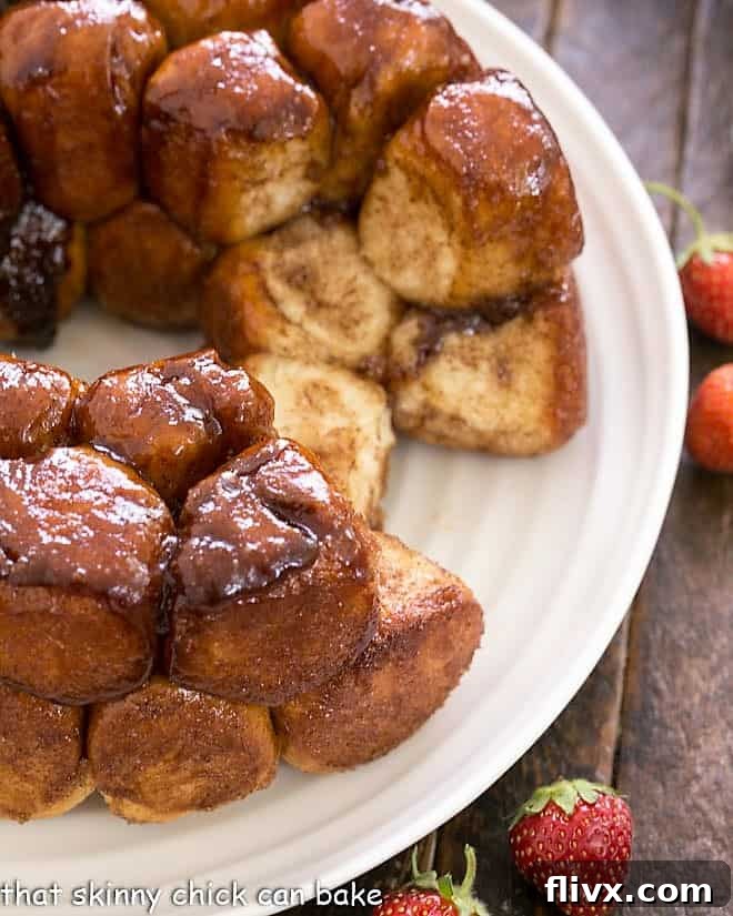 Overhead view of homemade monkey bread on a white plate with a few rolls removed.