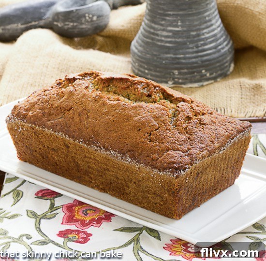 Sugar Crusted Zucchini Bread on a rectangular, ceramic serving tray, elegantly presented and ready for slicing.