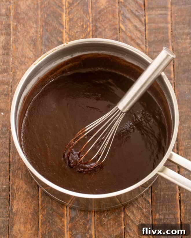 Butter, sugar and cocoa in saucepan for brownie batter.