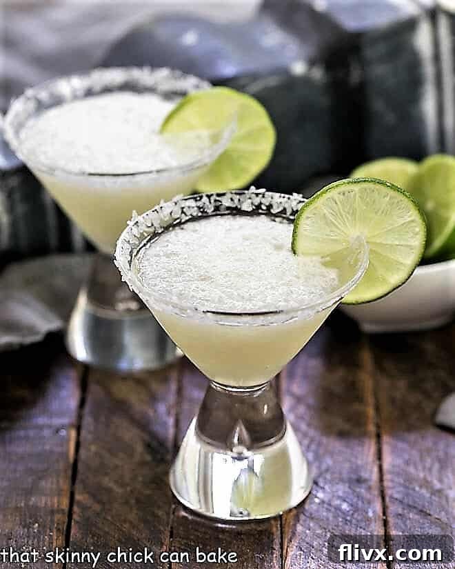 Easy 3-Ingredient Beer Margaritas in martini glasses with lime garnishes.