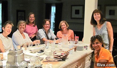 A group of smiling friends, the dedicated mousse taste testers, gathered in a cozy kitchen, enjoying their culinary adventure.