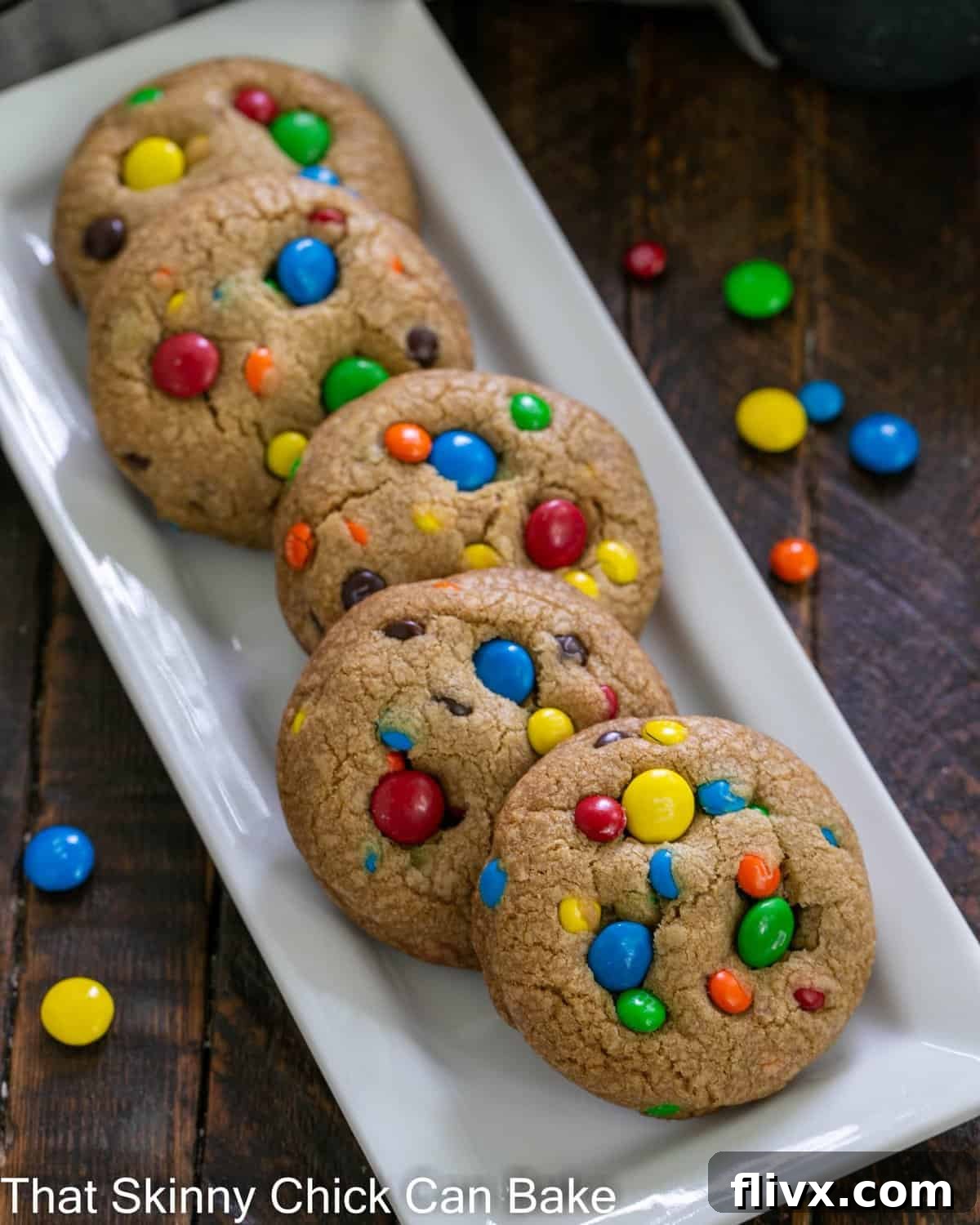 Overhead view of golden brown butter cookies with colorful M&Ms on a white serving tray, ready to be enjoyed.