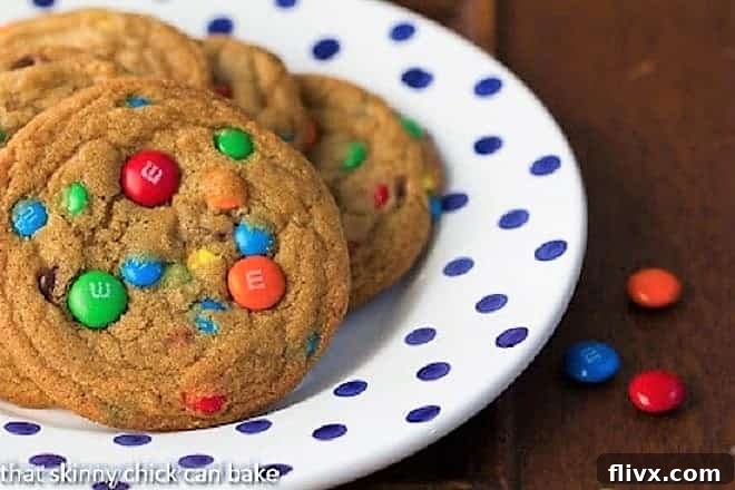 Brown Butter M&M Cookies on a blue and white polka dot plate, showcasing the rustic charm of homemade cookies.