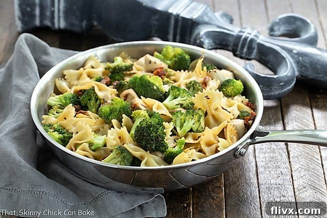 Chicken Broccoli Sun-dried tomato Pasta in a stainless steel frying pan, freshly cooked and ready to be served.