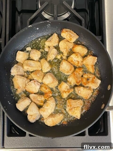 Second step for Garlic Parsley Chicken: Chicken pieces are evenly browned and cooked through in the skillet, showcasing a crispy exterior.