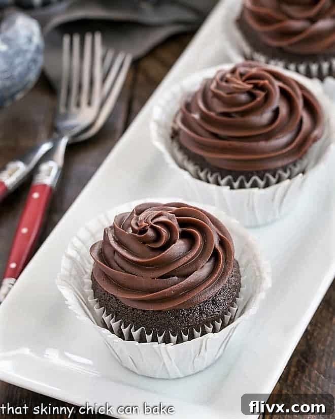 Blender cupcakes arranged on a white tray with red handled forks, ready to be enjoyed.