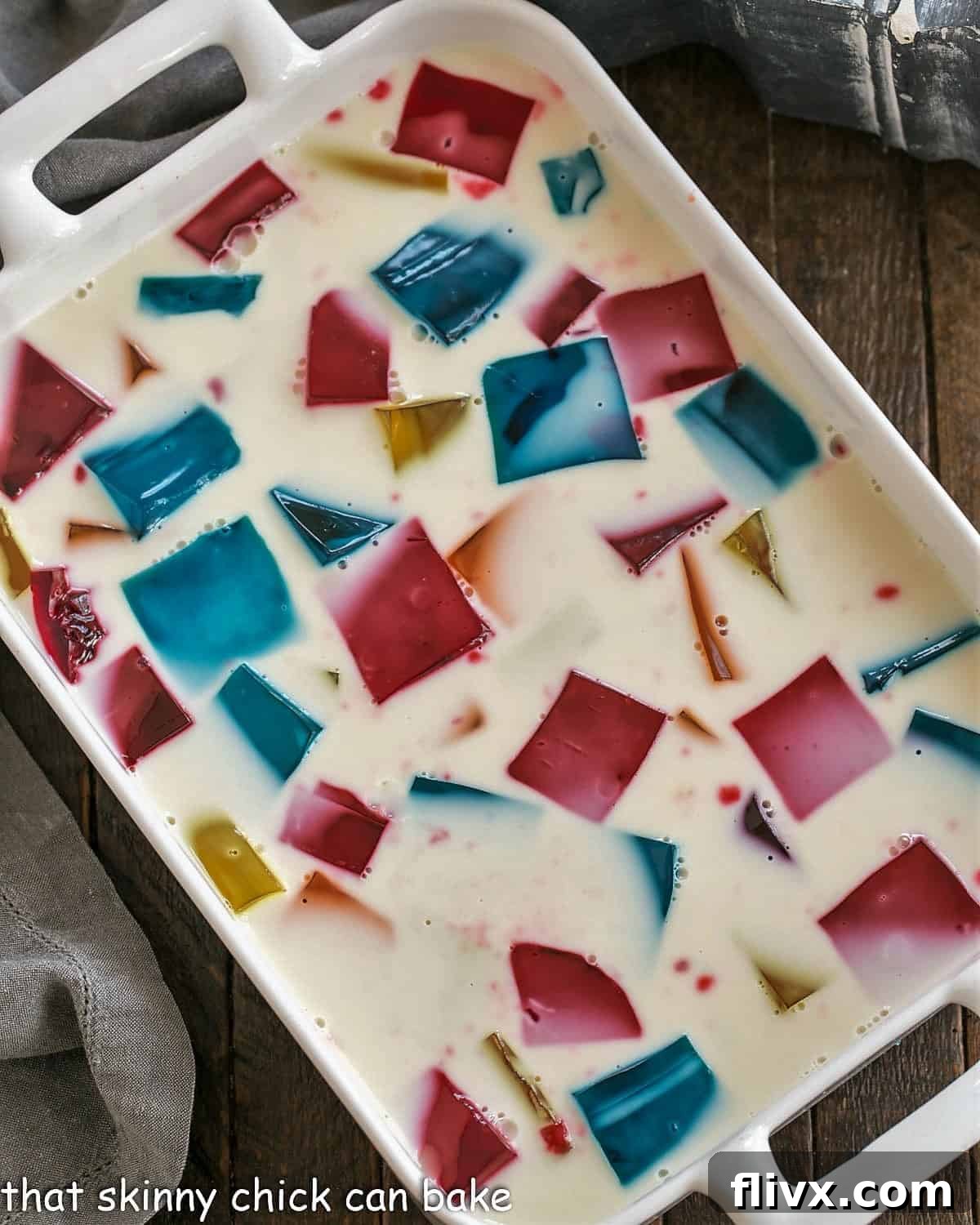 Overview of stained glass jello in a white casserole dish.