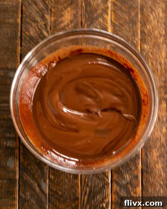 Step 1: Semisweet chocolate chips, unsweetened chocolate, and butter are measured into a heat-safe bowl, ready for melting.