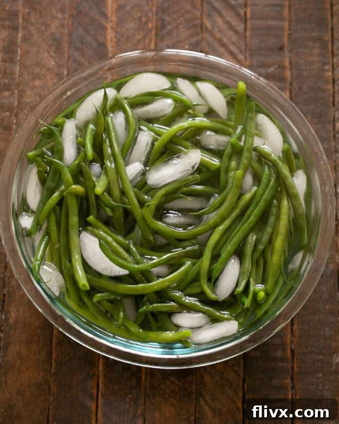 Italian Green Beans Step 2: Cool green beans in ice water to stop cooking.