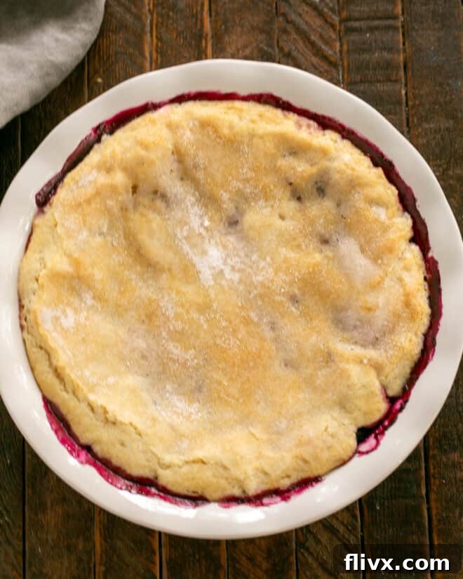 Sprinkling sugar over the cobbler topping before baking.