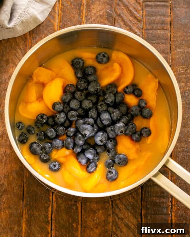 Mixing cornstarch, brown sugar, water, and fruit in a saucepan.