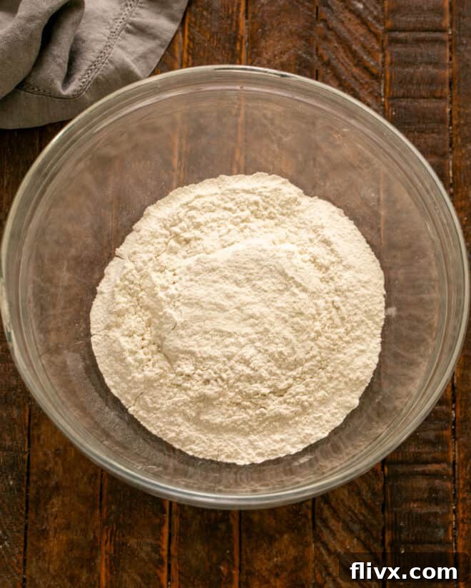 Sifting dry ingredients for the cobbler topping.