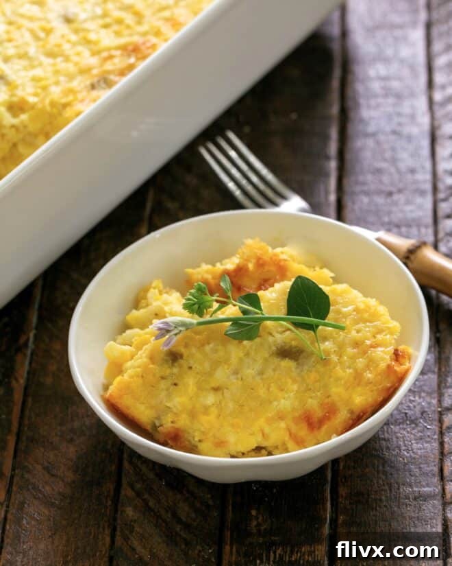 Fresh Corn Casserole in a small white bowl with an herb garnish.