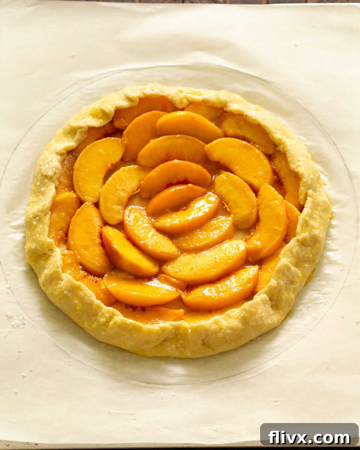 Step 6: The outer edges of the galette dough are gently folded up over the peach filling, creating natural pleats to enclose the fruit and its juices during baking.