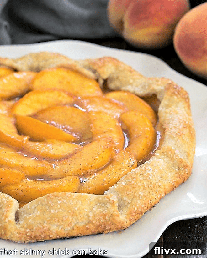 A mesmerizing partial closeup of a baked peach galette, showing the golden-brown, pleated crust and the luscious, bubbling peach filling, ready to be enjoyed.