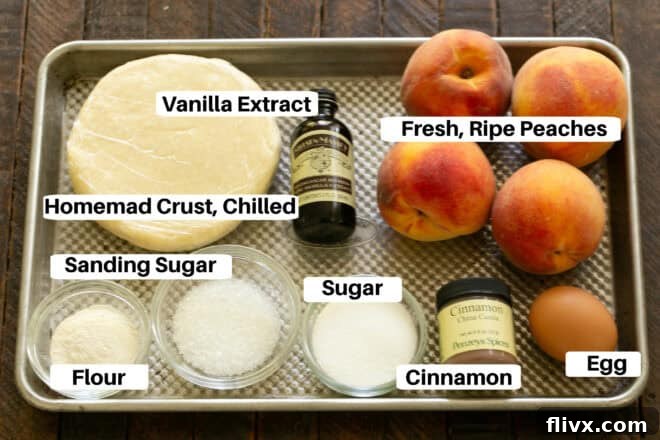 Close-up view of peach galette filling ingredients on a sheetpan, including fresh sliced peaches, vanilla extract, cinnamon, sugar, and flour, all ready for assembly.