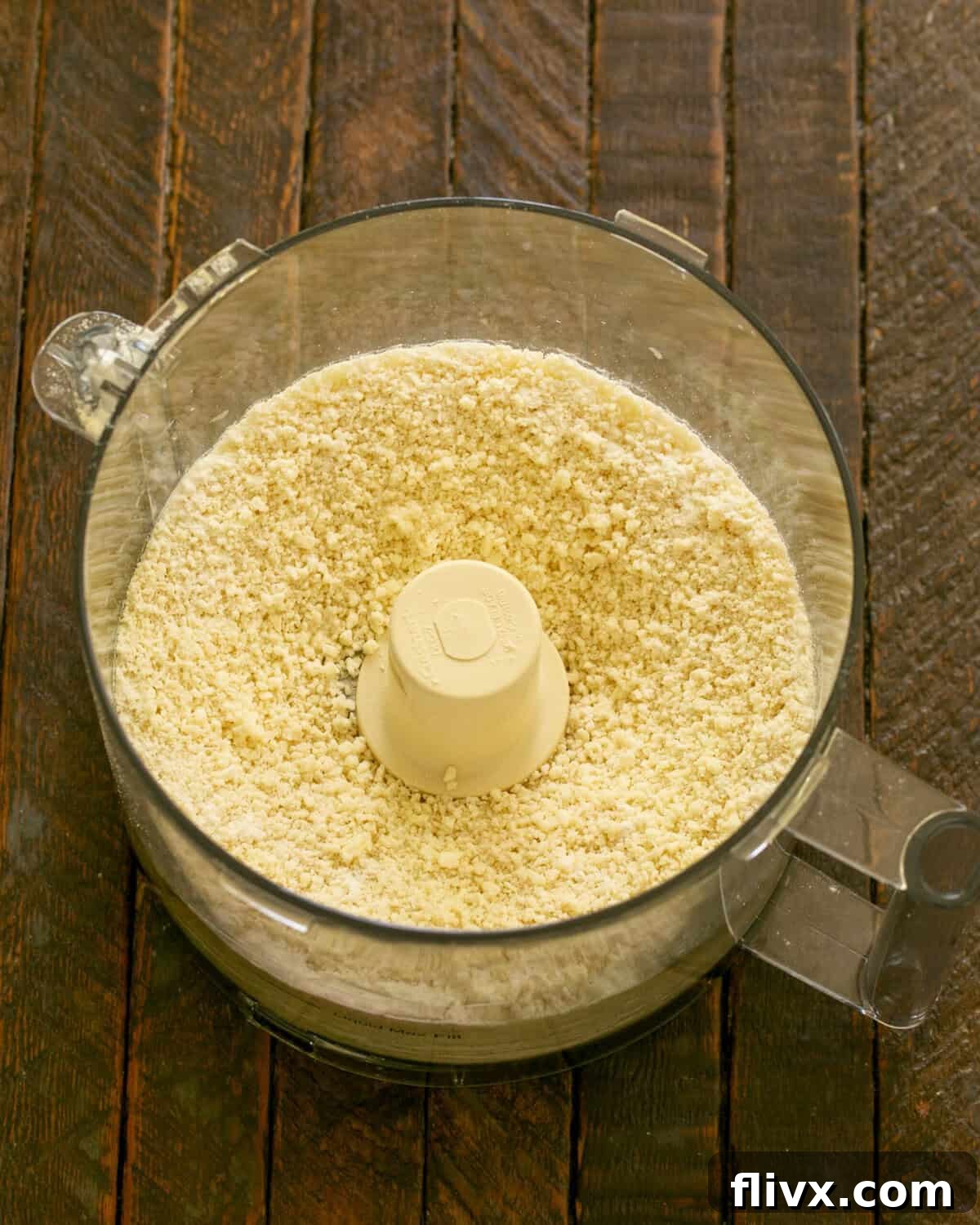 Step 1: Ingredients for the crust, including flour, sugar, salt, and cold butter, being pulsed in a food processor until it resembles coarse cornmeal.