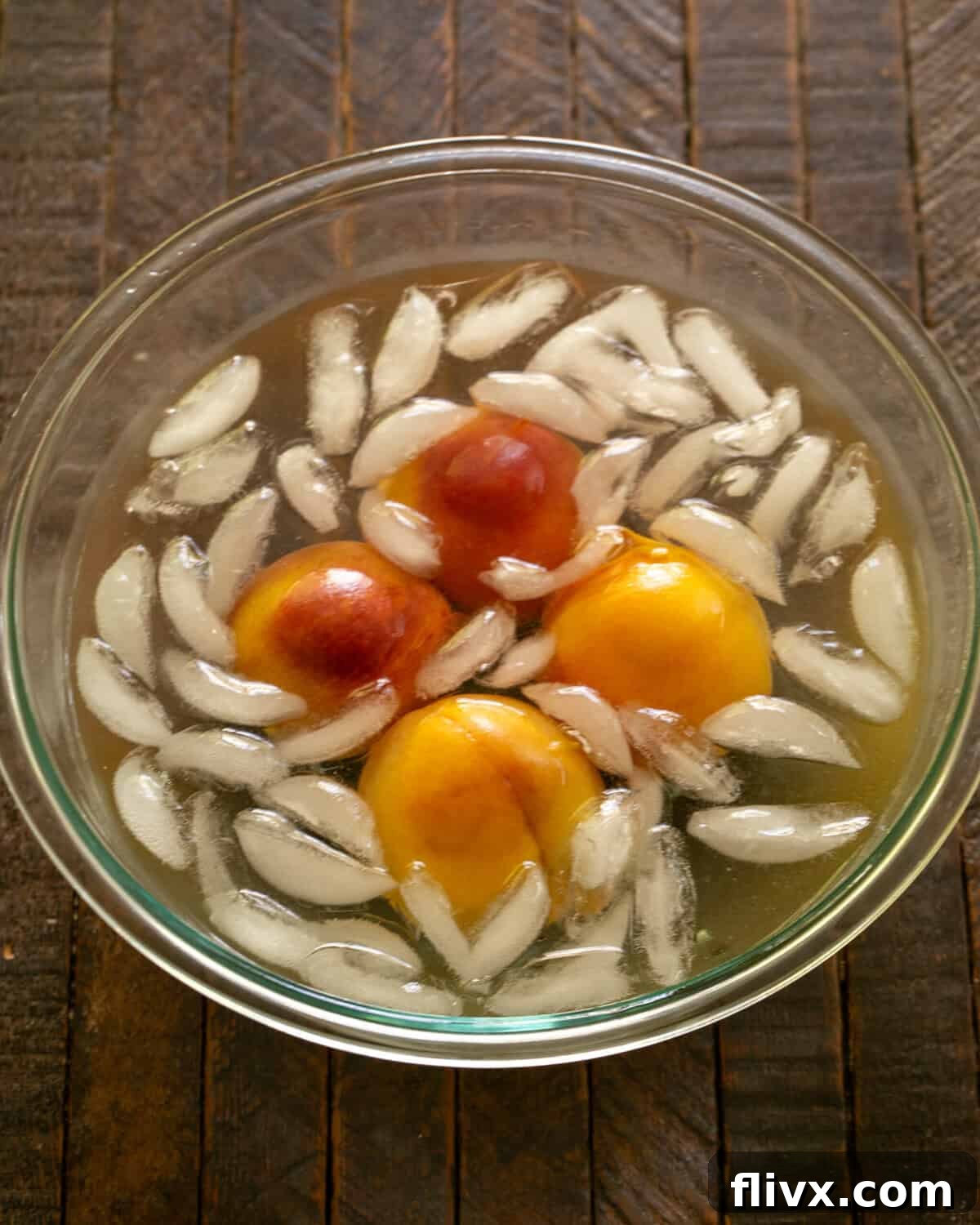 Step 4: Peaches submerged in boiling water, then transferred to an ice bath, demonstrating the blanching process for easy peeling and subsequent slicing.