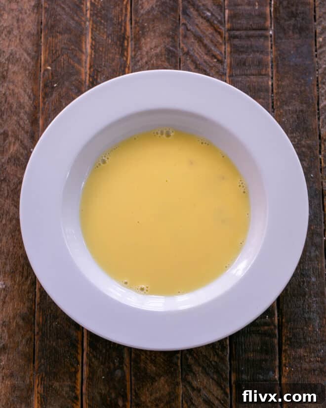 Golden Brown Sweet and Savory Monte Cristo 3 Bowl of egg mixed with milk.