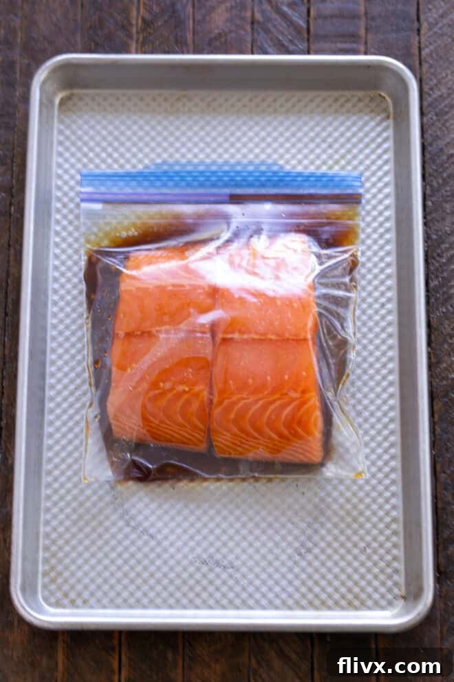 Date Night Grilled Salmon 5 Salmon fillets submerged in marinade inside a Ziploc bag, ready for refrigeration.