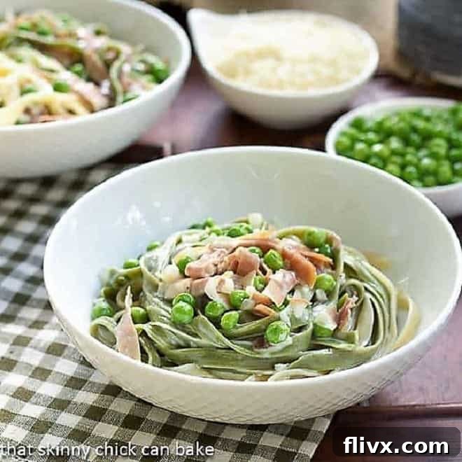 A beautifully presented bowl of Straw and Hay Pasta, showcasing the vibrant green and yellow fettuccine strands.