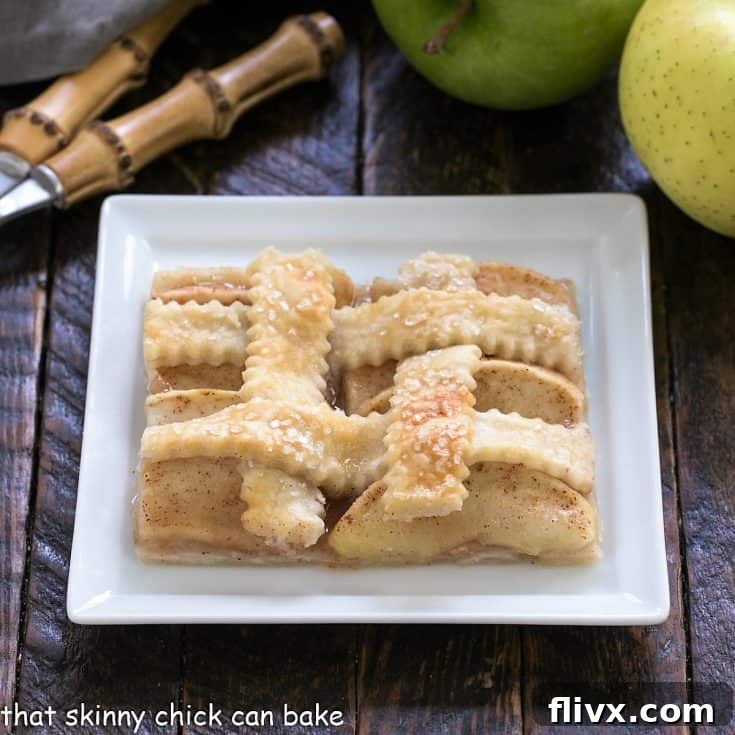 Slice of apple slab pie on a square white plate