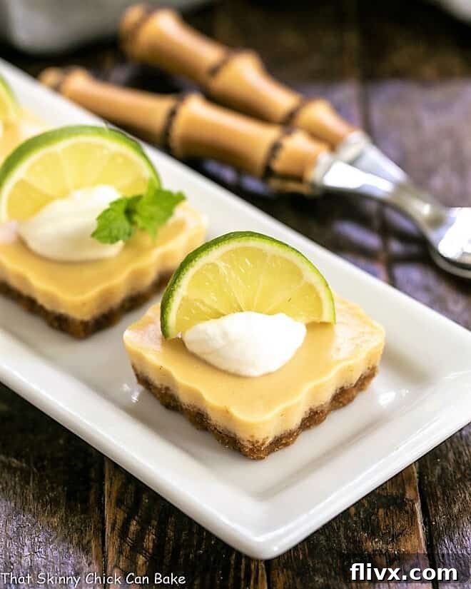 Key Lime Tartlets on a white serving tray, showcasing their vibrant color and delicate crust.