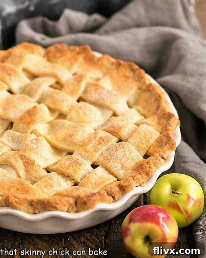 Perfect Apple Pie with a golden-brown lattice crust in a rustic ceramic pie plate, ready to be served.