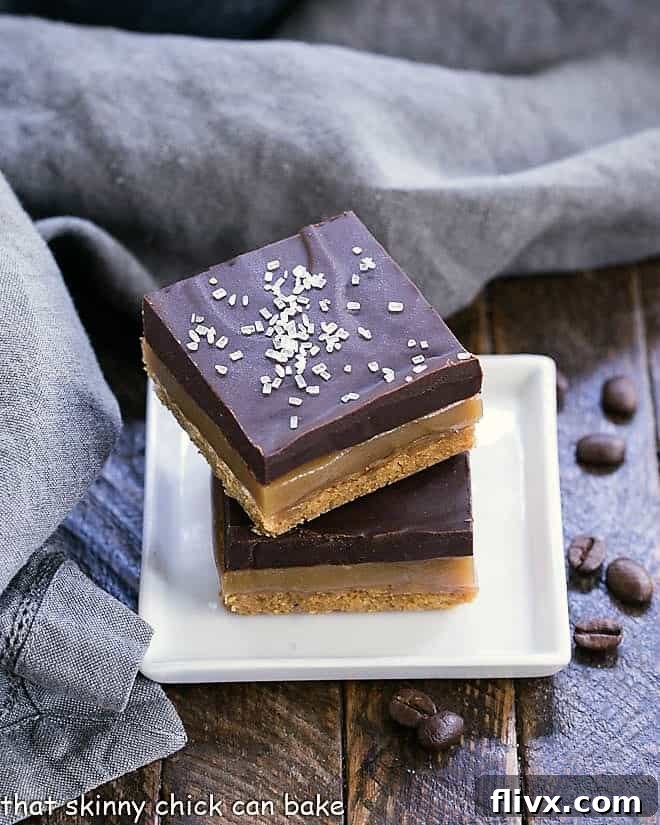 Stacked Caramel Espresso Bars on a small square white plate, showcasing their rich layers.