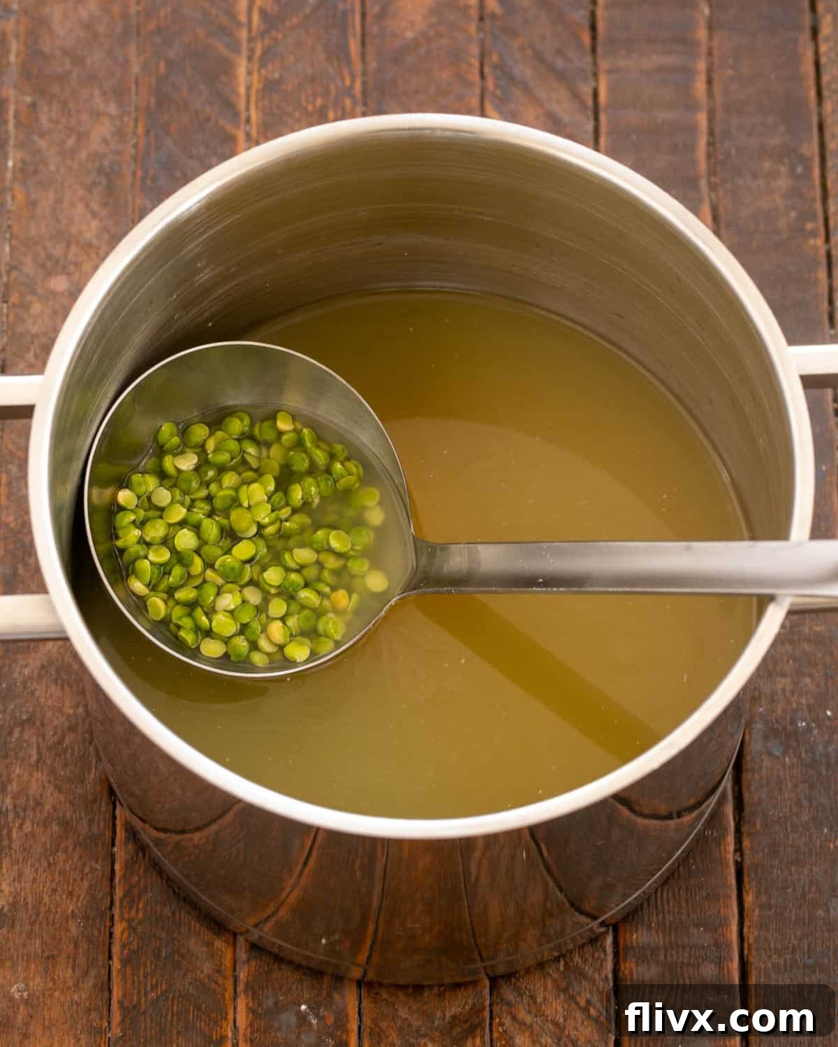 Green split peas simmering in broth until tender and creamy.