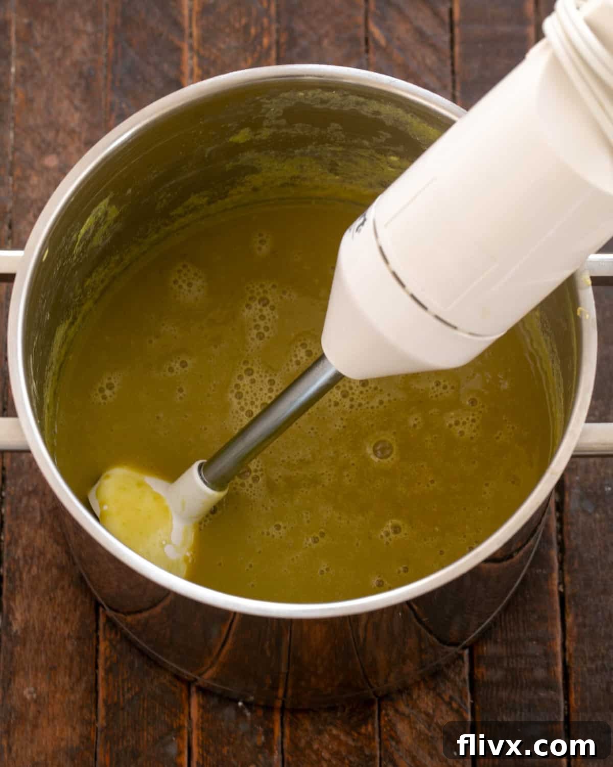 Pureeing cooked split peas until smooth and seasoning with herbs.