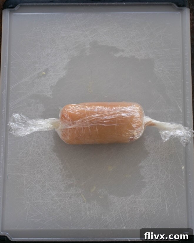 Step 3: Roll tightly in plastic wrap.