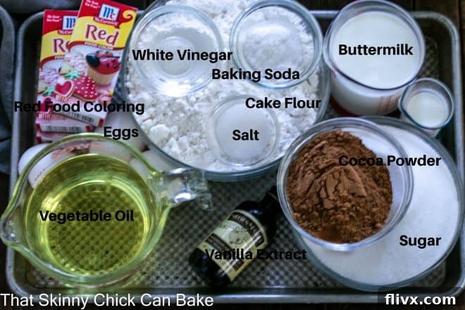 Red velvet cake ingredients in small glass bowls with labels on a sheet pan.