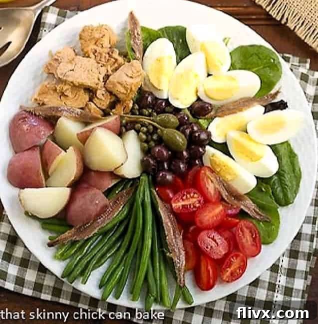 A beautifully arranged Classic French Salade Niçoise with fresh vegetables, tuna, and eggs.
