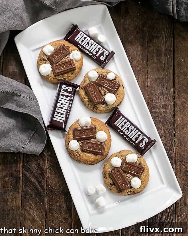 A delectable spread of S'mookies, also known as Gooey S'mores Cookies, beautifully arranged on a white ceramic serving tray, ready to be enjoyed.