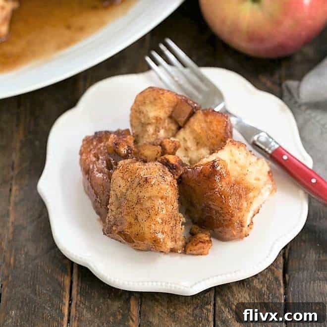 Delicious Crock Pot Apple Monkey Bread with a rich caramel glaze, garnished with a dusting of cinnamon.