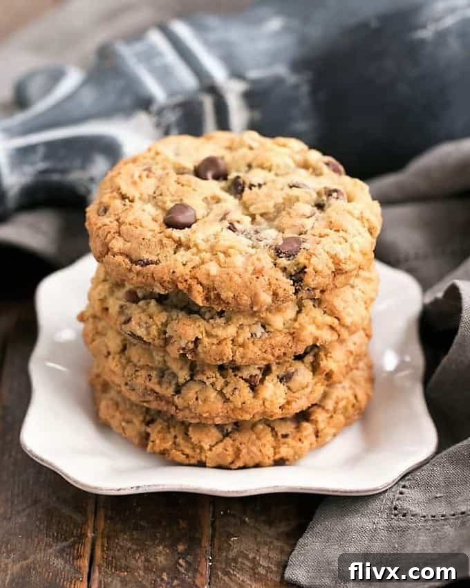A plate of hearty Cowboy Cookies loaded with oats, coconut, chocolate chips, and pecans.