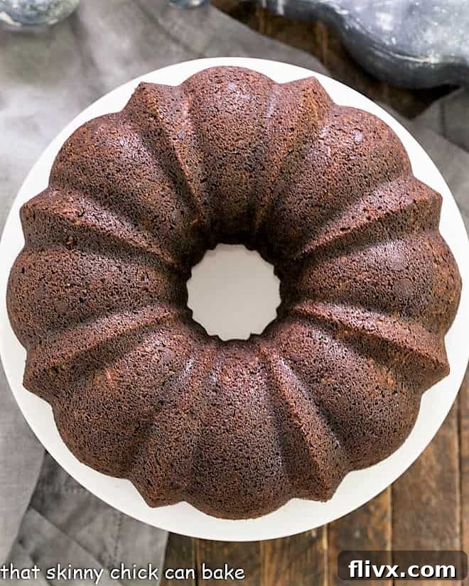 A beautiful Chocolate Zucchini Bundt Cake, moist and dark, with a light dusting of powdered sugar.