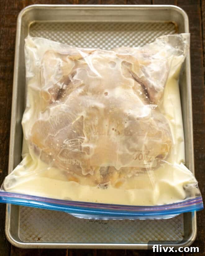 Buttermilk and whole chicken in a Ziploc bag.