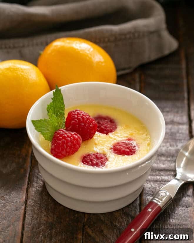 Meyer Lemon Mousse in a white ramekin with a red handled spoon.