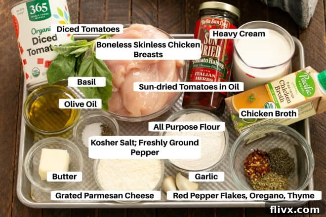 Fresh ingredients laid out for Marry Me Chicken including chicken breasts, herbs, and sun-dried tomatoes.