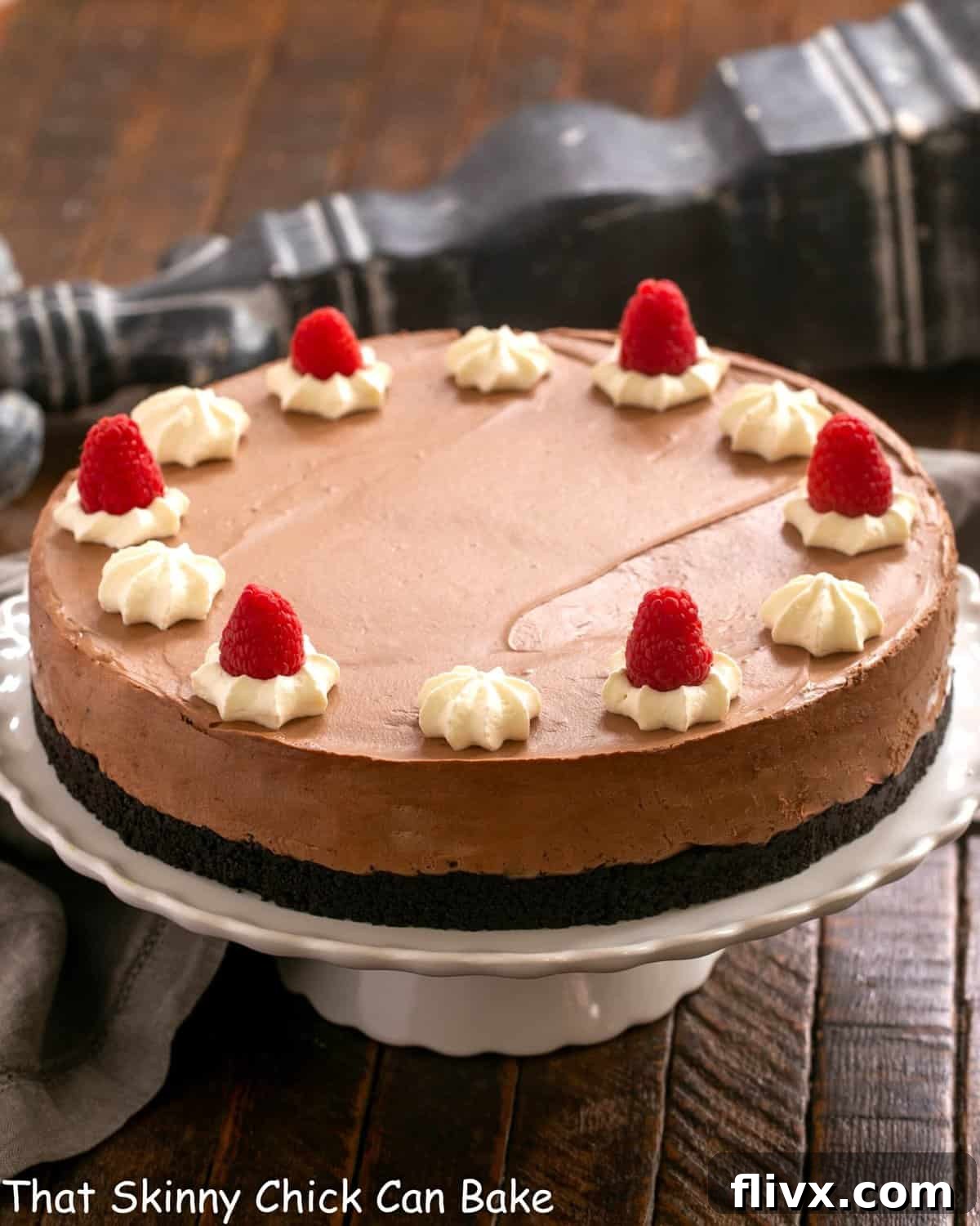 Chocolate Mousse Cake on a white ceramic cake stand, ready to be served.