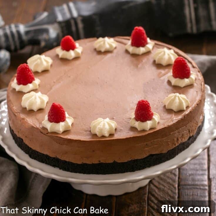 A stunning Chocolate Mousse Cake beautifully presented on a pristine white cake stand.