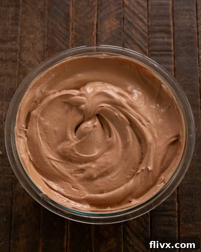 The whipped egg whites being gently folded into the chocolate mixture, creating a light and airy mousse.